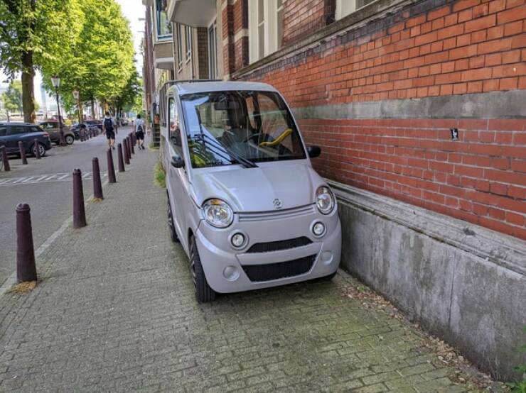 "Tiny two seater car (about half the width of an Amsterdam sidewalk)"