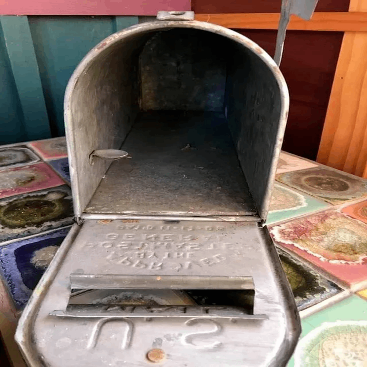 Small round “shelf” in old mail box? Answer: It’s used as a space to leave change for postal workers for additional postage.