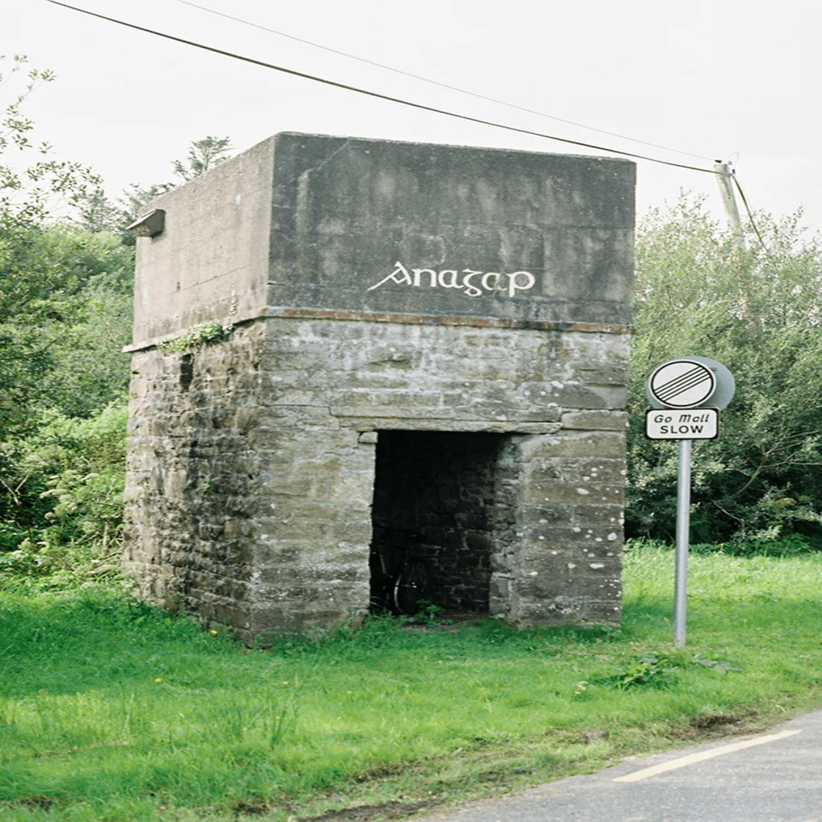 Found this building while I was hiking in west Kerry, Ireland. Answer: A water tower used to refill steam engines back when a rail line ran there.