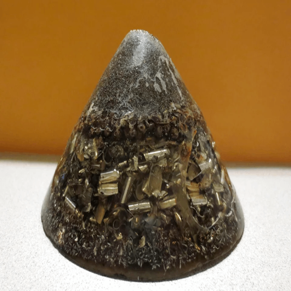 Found Underground in Edmonton, Alberta. Made of metal bits encased in an acrylic like substance. Smooth flat bottom. Answer: Orgonite. A device (?) used to harness the power of Orgone, an energy or universal life force that somebody probably just made up. Anyway, it’s that.