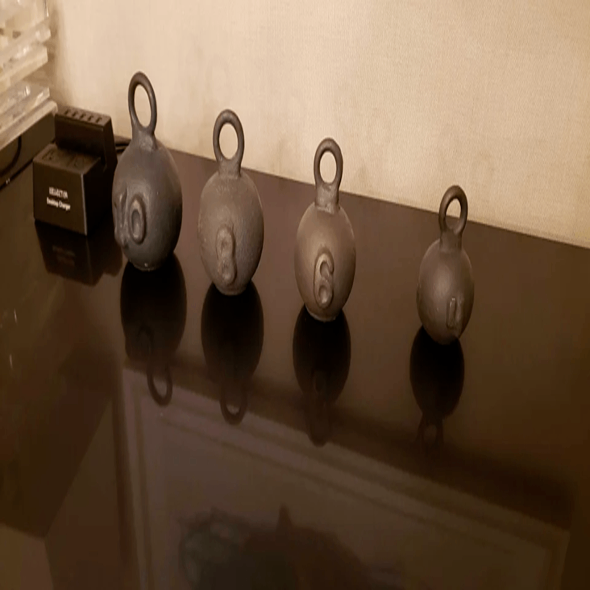 What are these weird weights that showed up in my hotel room while I was out? Answer: fishing weights for deep sea fishing, and not, as I suspected, kettlebells for gnomes.