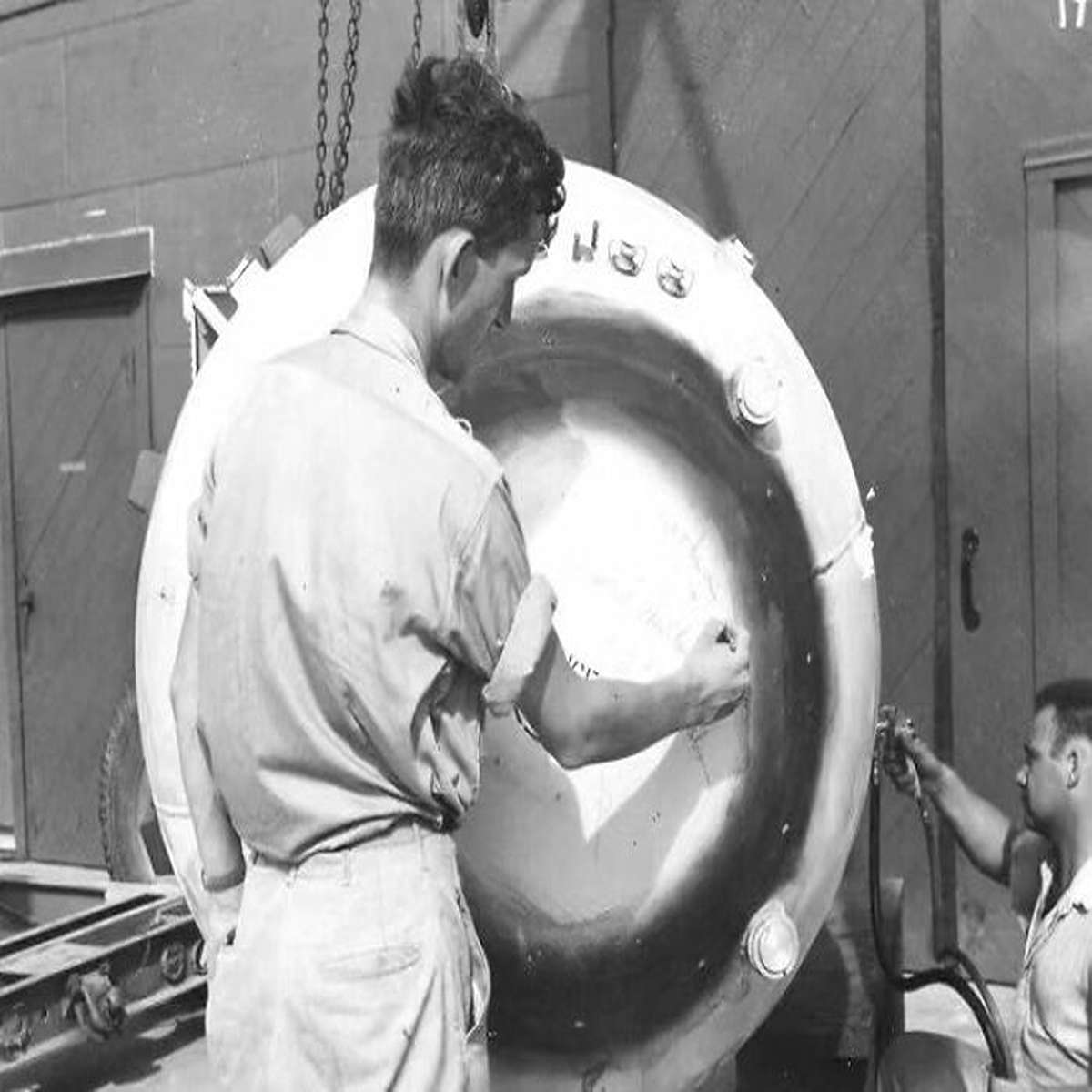 Nuclear Physicist Norman Ramsey Signs The 'Fat Man' Nuclear Weapon, Later Dropped On Nagasaki On 6 August, 1945. 60-80,000 Japanese Civilians Were Killed As Large Swaths Of The City Was Instantly Obliterated