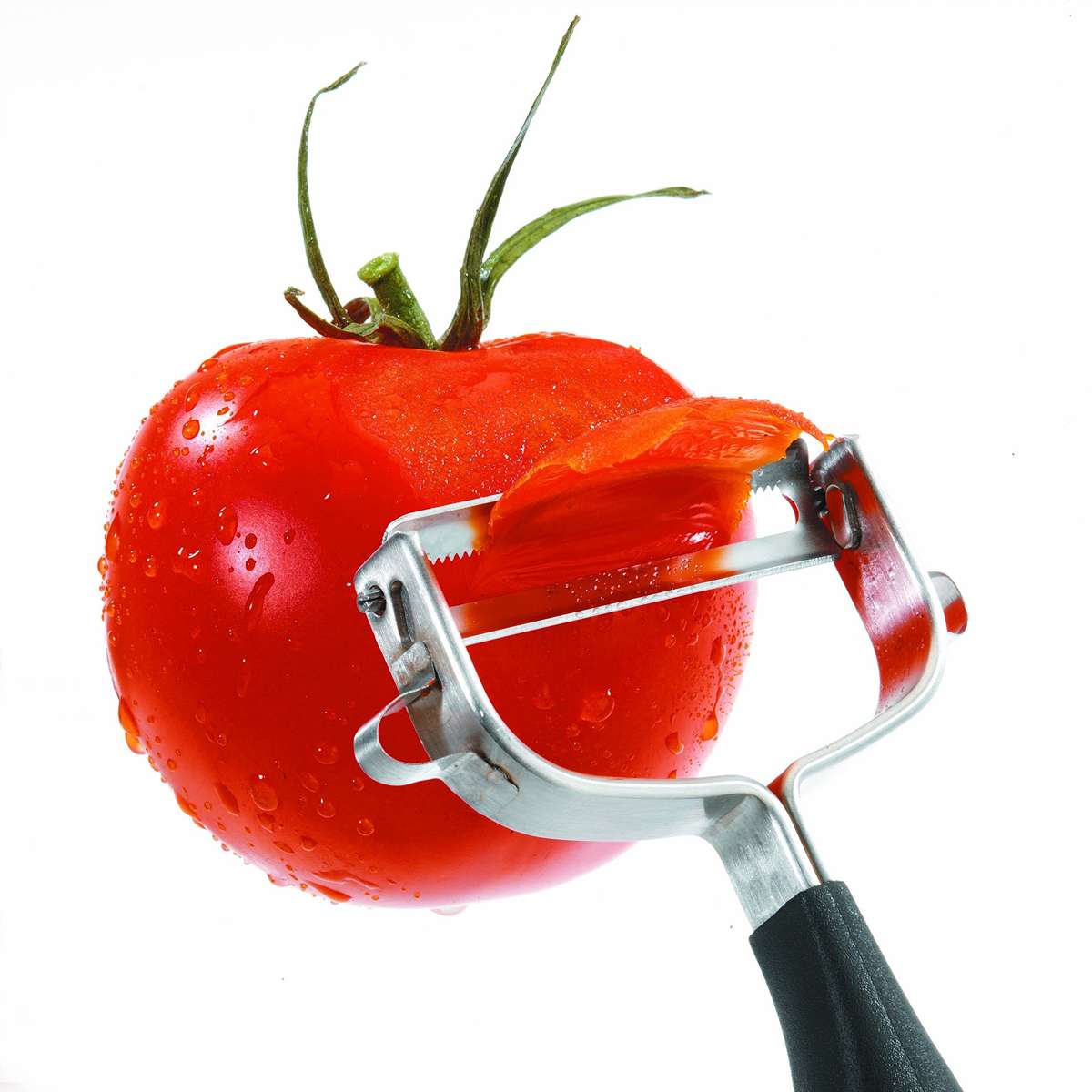 Get a tomato peeler. It's great to peel tomatoes... And everything else. It's so much better than any other peeler. Only issue is you get so addicted that when on holidays you sometimes ponder whether you should bring one with you.