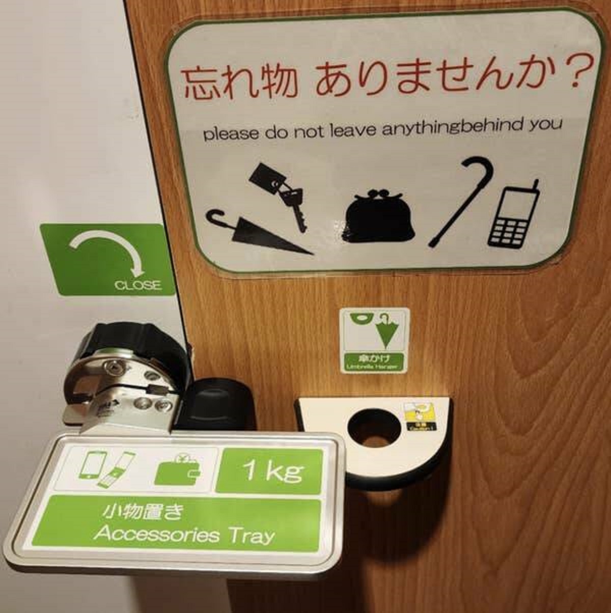 This toilet stall in Japan has a tray for your personal items and reminders to make sure you don't forget them.