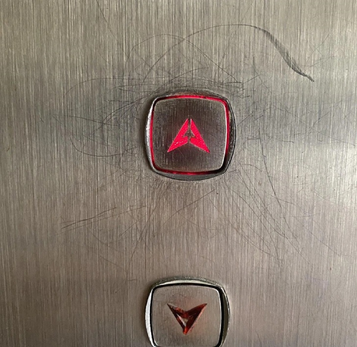 “Scratches around an elevator button after years of people trying to press it with a key and missing”