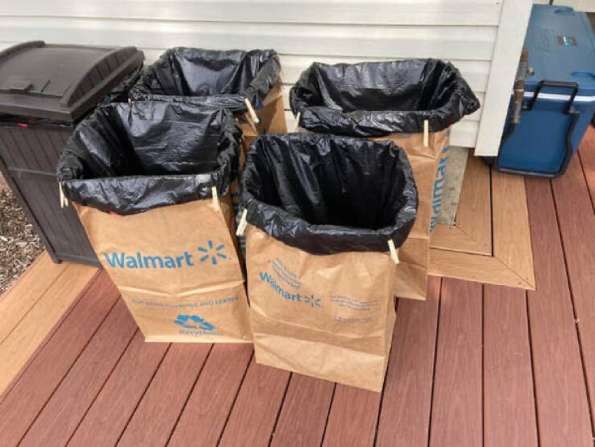 "How to make impromptu garbage bins for a party. I am having a graduation party for my daughter tomorrow. We are having a large crowd. I wanted to place a few garbage bins outside around the yard, so here’s what I did. I placed a 33-gallon plastic bag inside of a lawn and leaf palate bag. I cuffed the top, rolling twice, and clipped the plastic bag to the cuff."