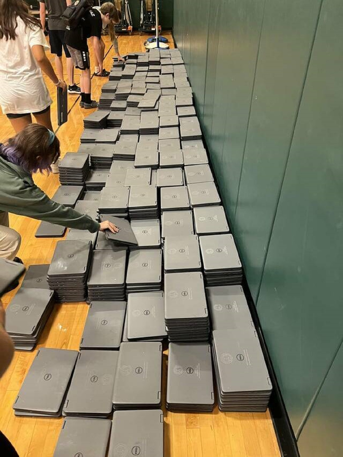 My school stores laptops in a pile on the floor