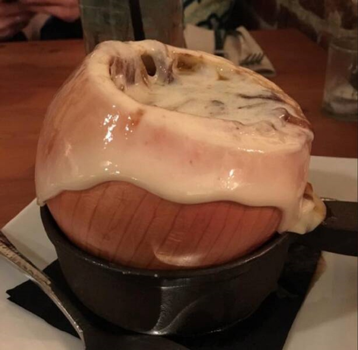 “A restaurant serves French onion soup in a real onion.”