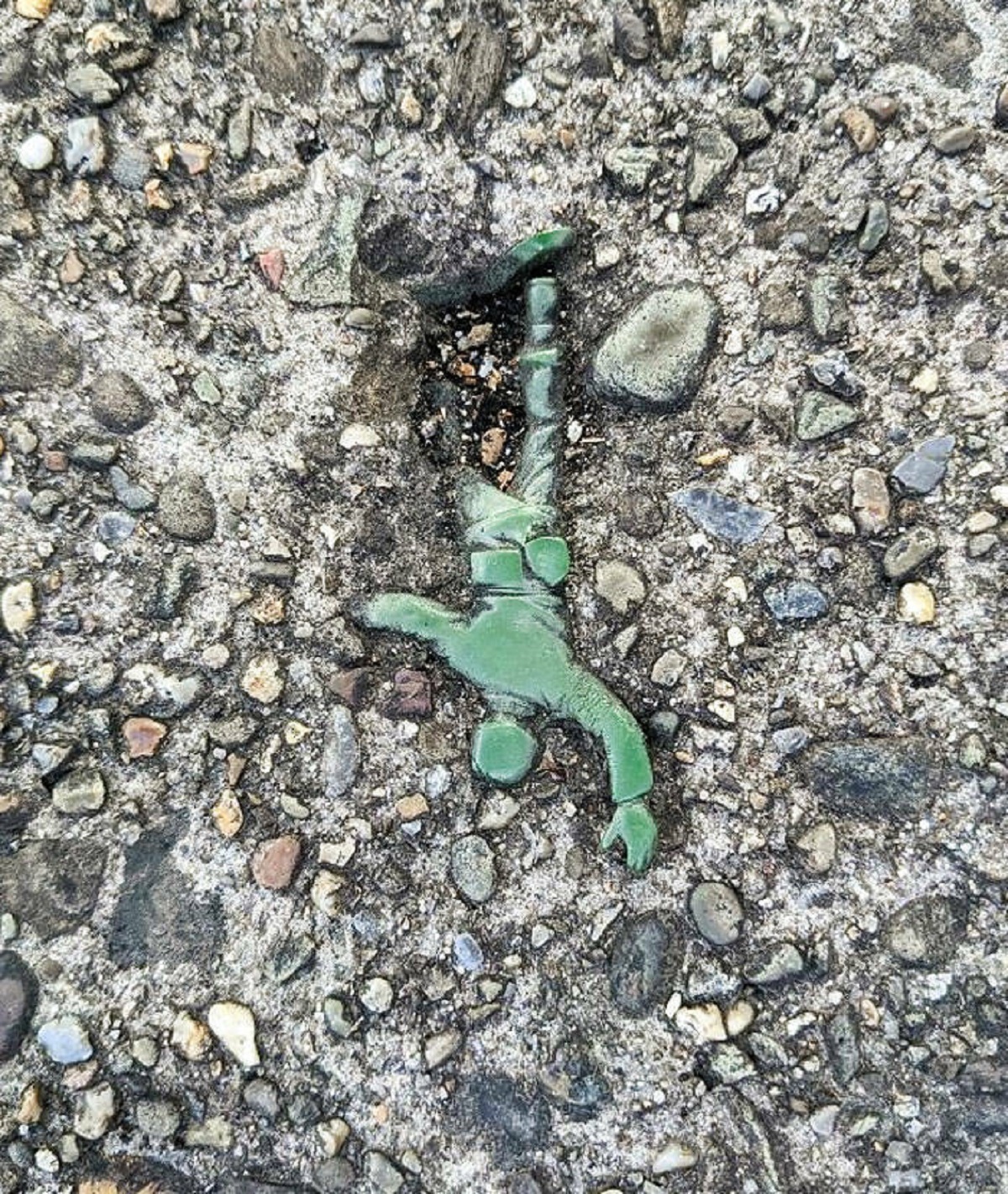 "Today On My Walk I Found An "Army Man" Embedded In The Sidewalk"