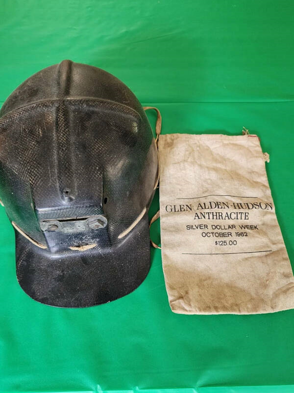 “Grandfather’s child size coal mine helmet and paybag.”