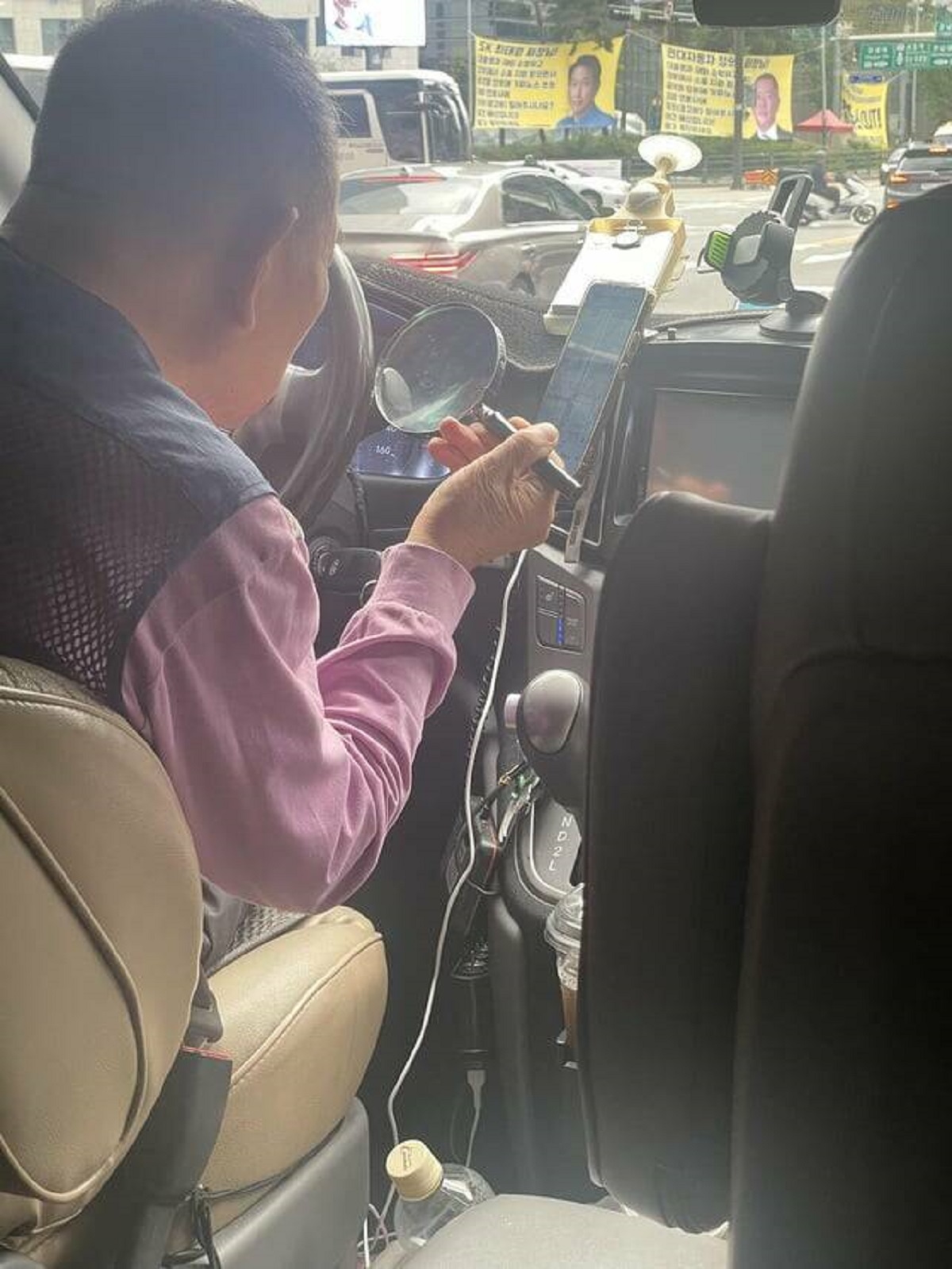 "My Lyft driver in Seoul using a magnifying glass to see directions on his phone"