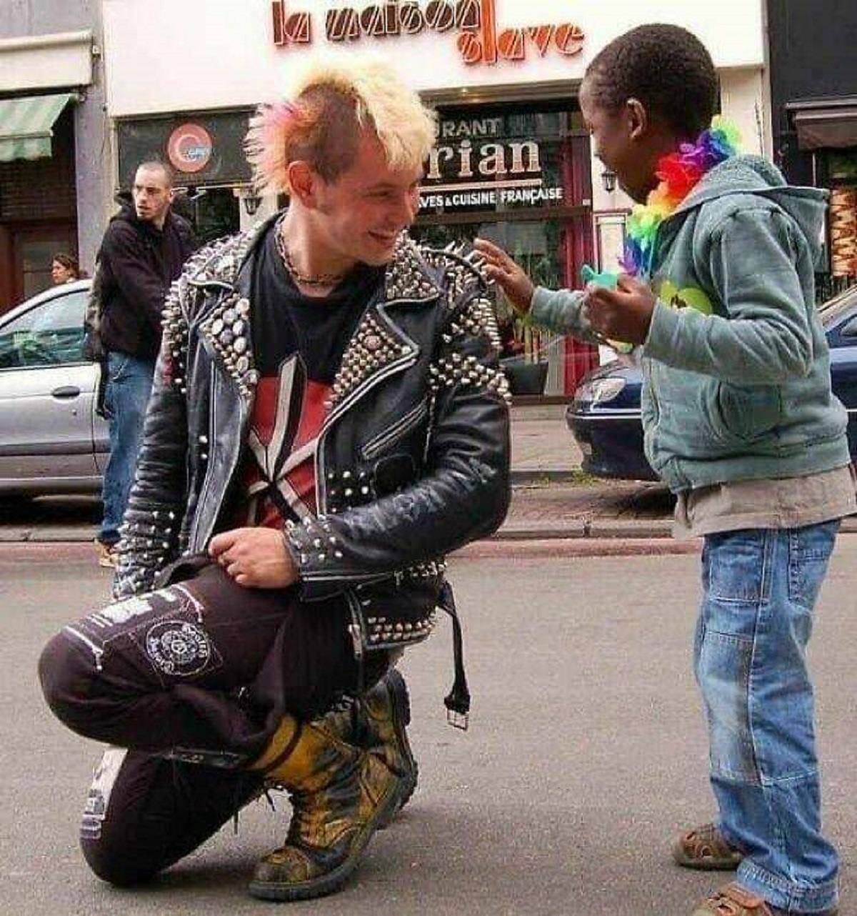 "Punk Rocker Lets Curious Child Touch His Jacket. 2012"