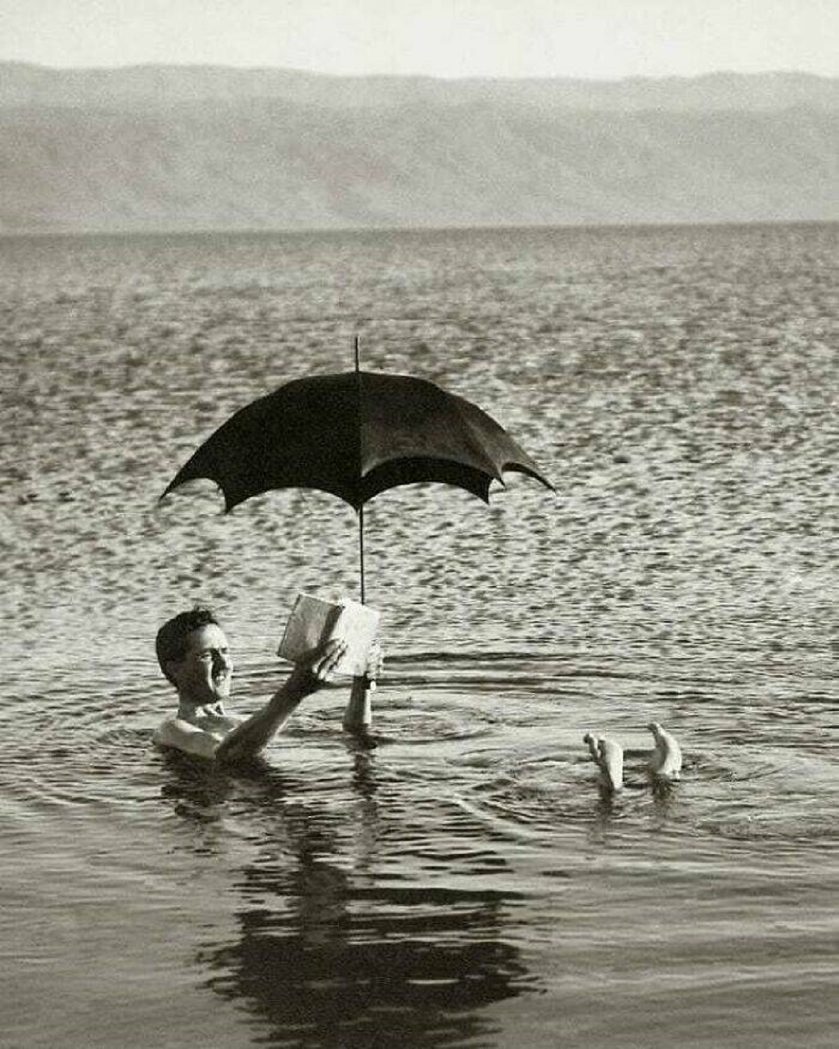 "A Man Floating In The Dead Sea With A Book And An Umbrella. 1920"