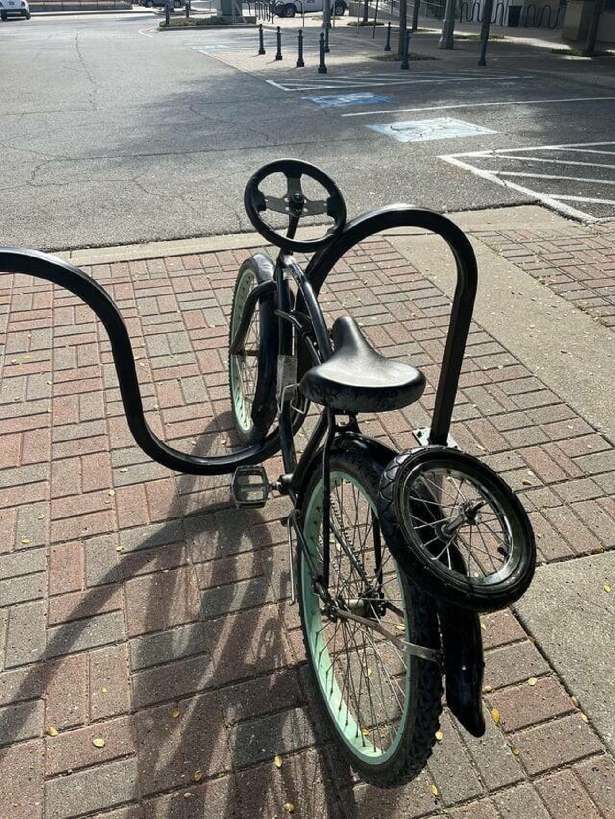 "This bike that has 3 wheels, a steering wheel, and isn’t locked up"