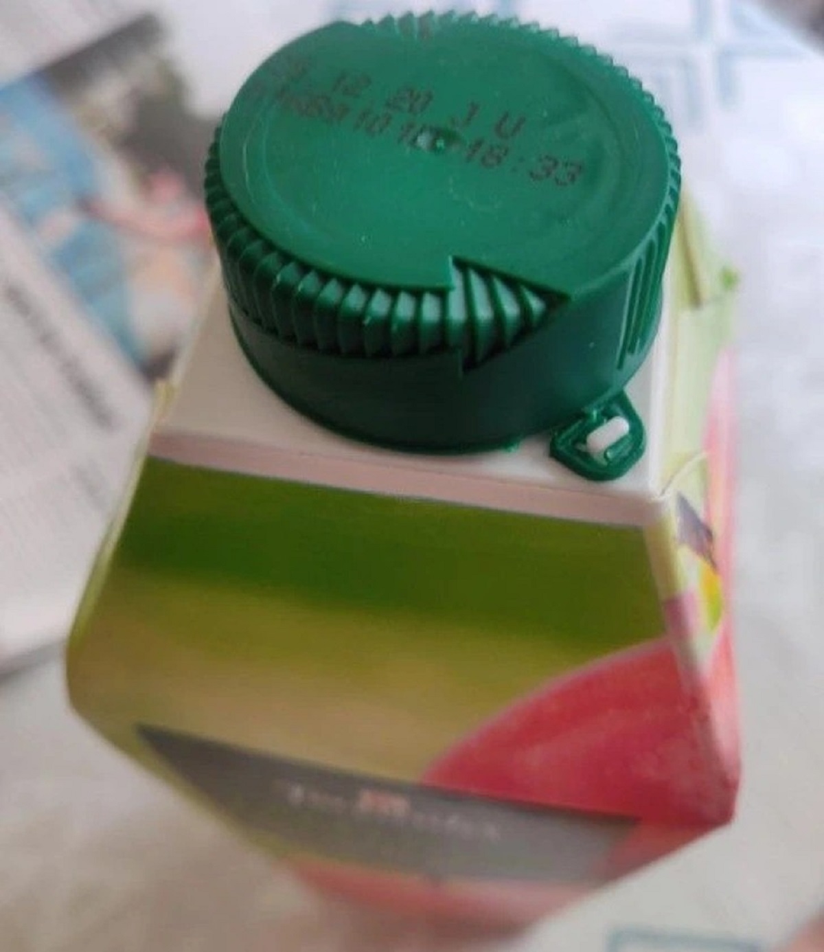 “The cap of this apple juice bottle has an engraved arrow that indicates the direction it should be rotated in order to be opened.”