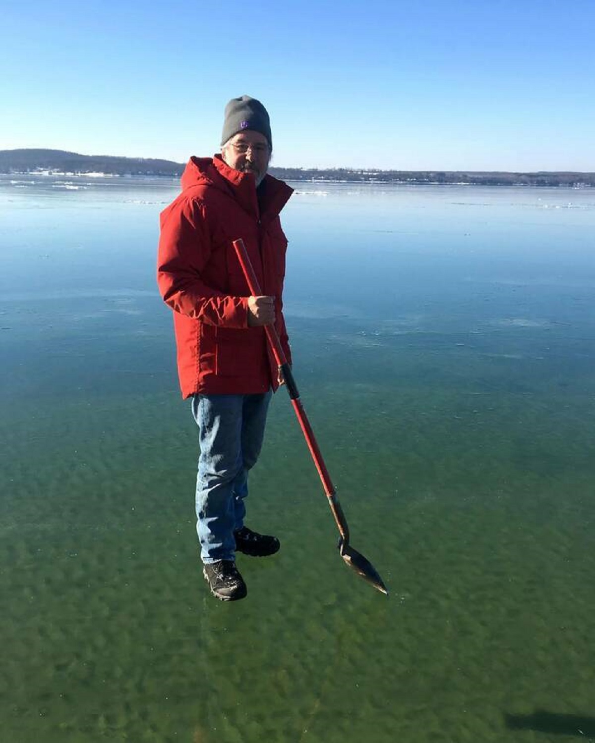 “Man standing on frozen Michigan Lake.”