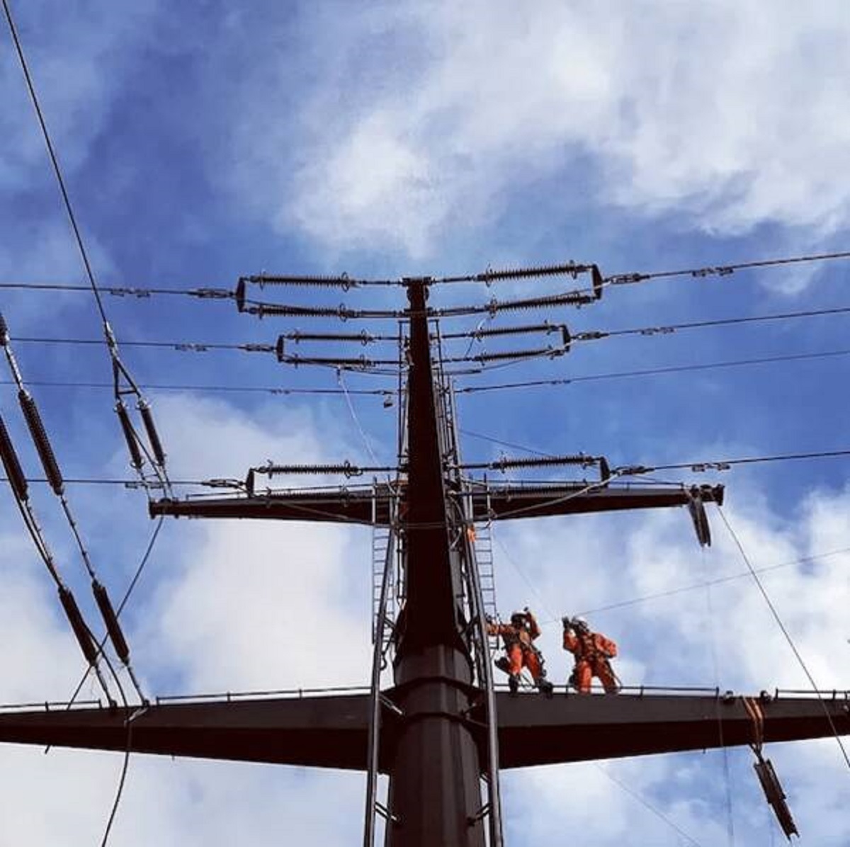 "Workers on a power line."