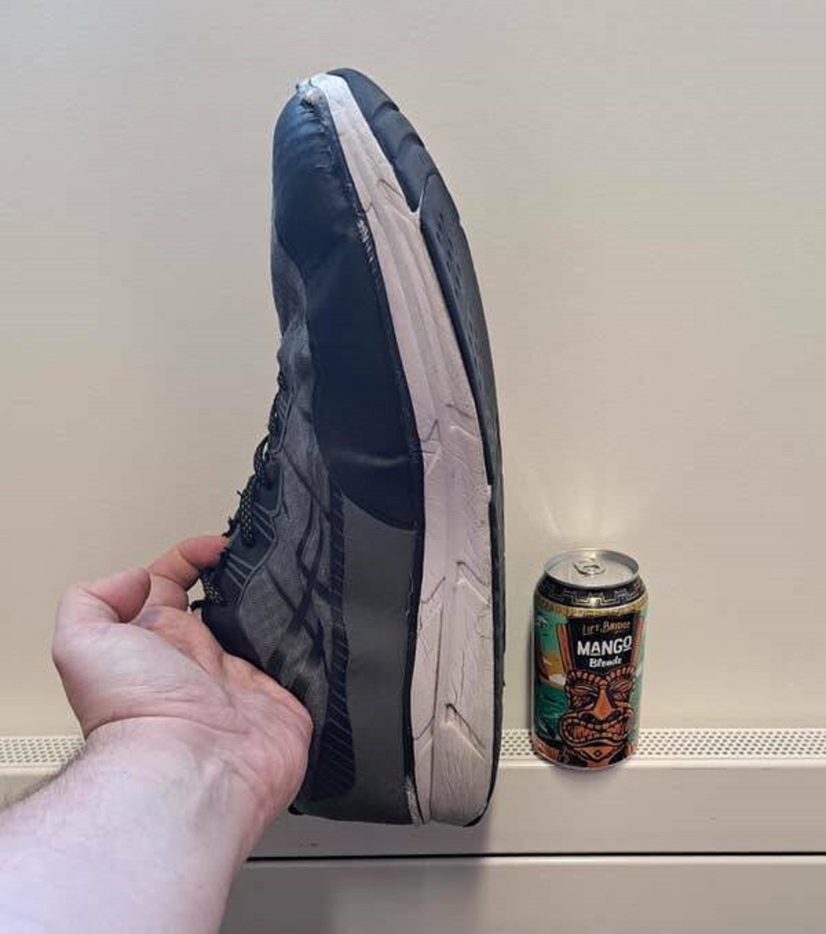 This is how big a size 18 shoe is compared with a can of soda: