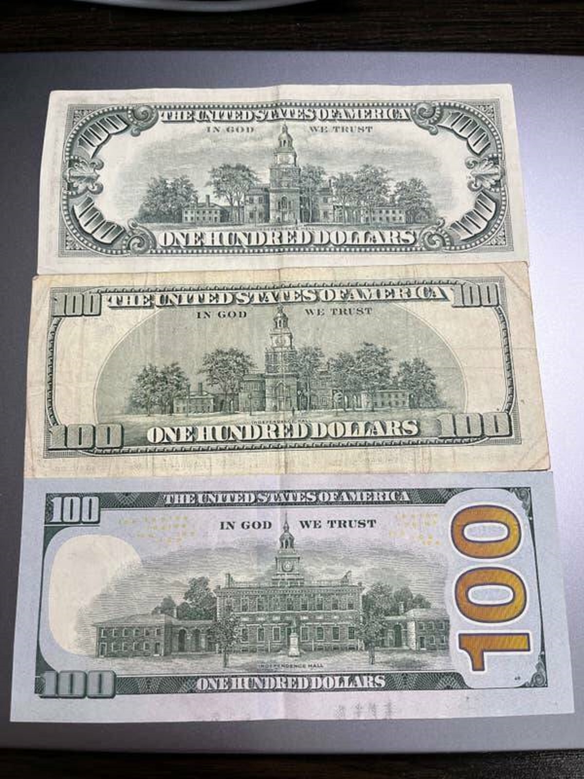 This is what a $100 bill looked like in 1977, 2003, and 2017: