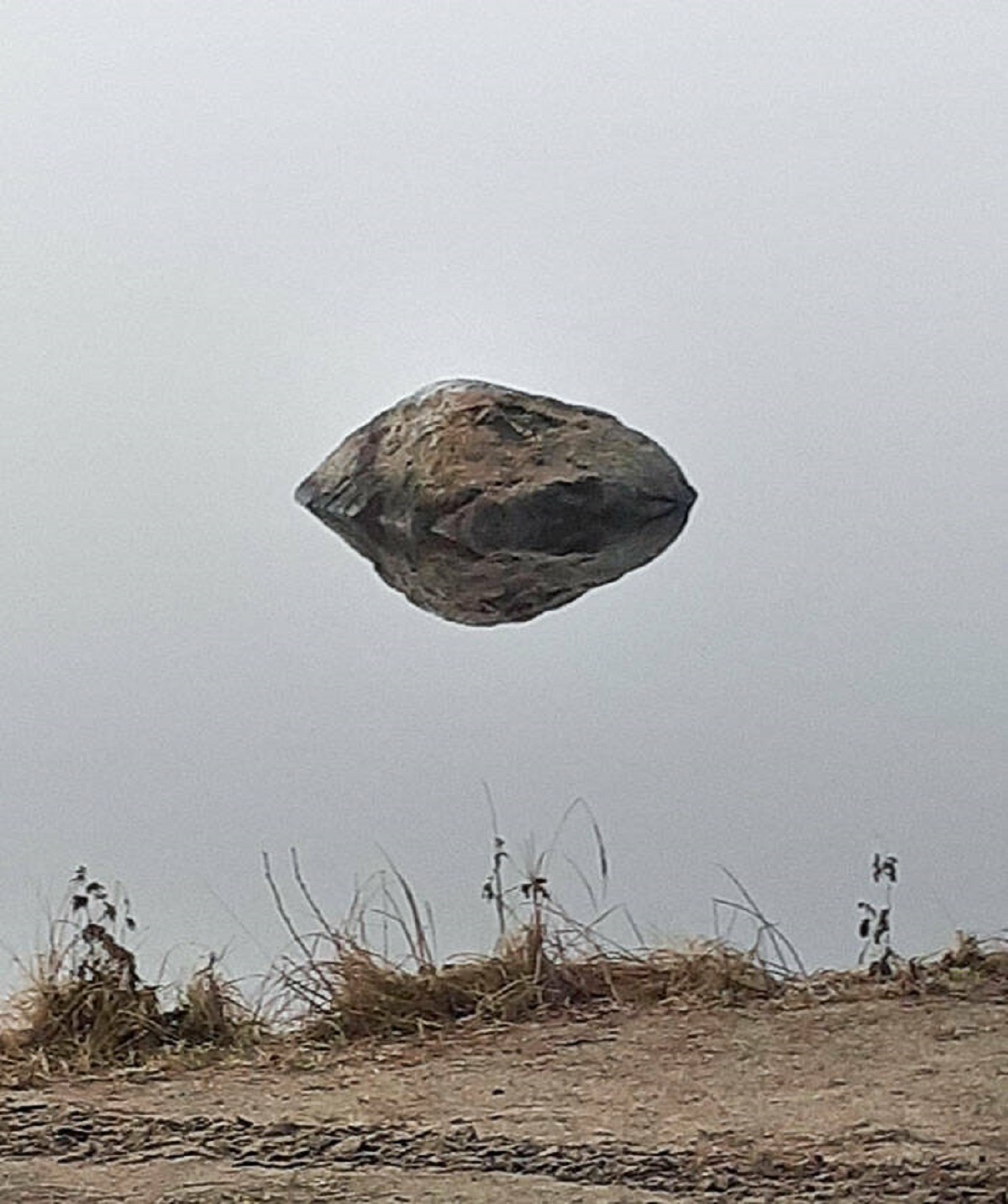 "This Rock Is Just Reflecting In Water That You Can't See Because Of The Fog"