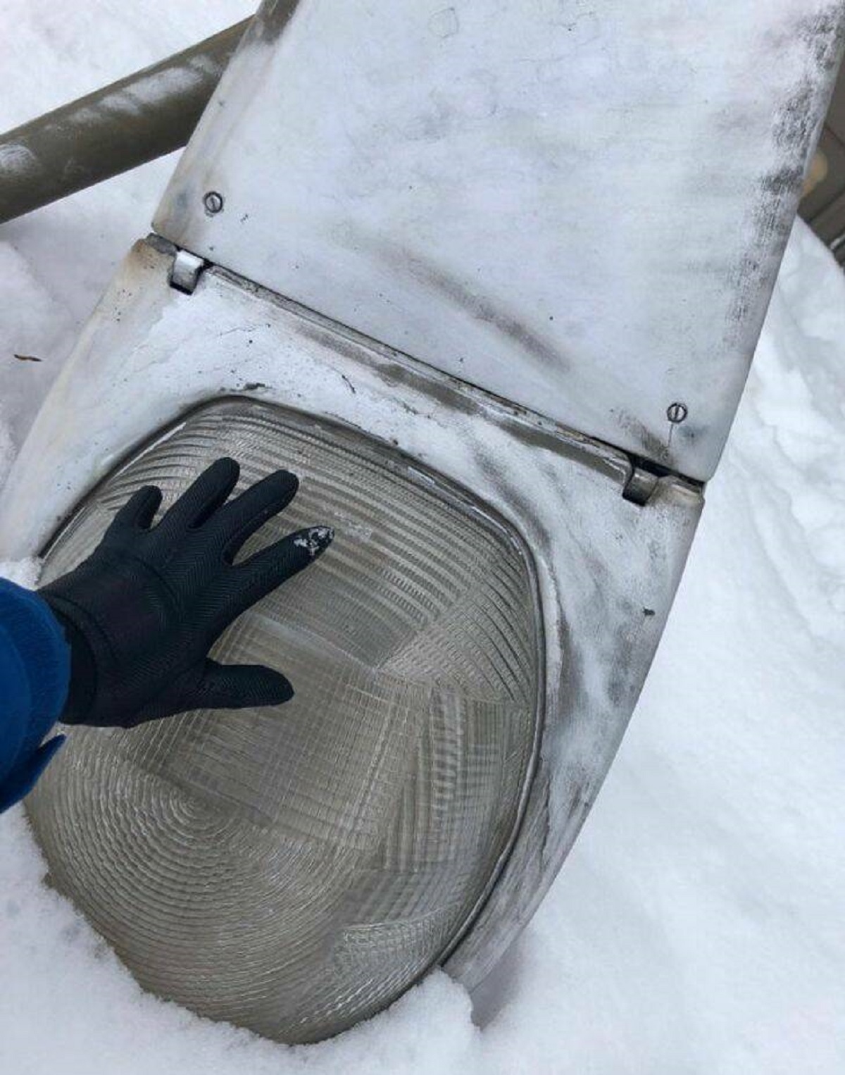 “A street lamp fell over into the snow outside my apartment. Turns out they’re massive — my hand for scale.”