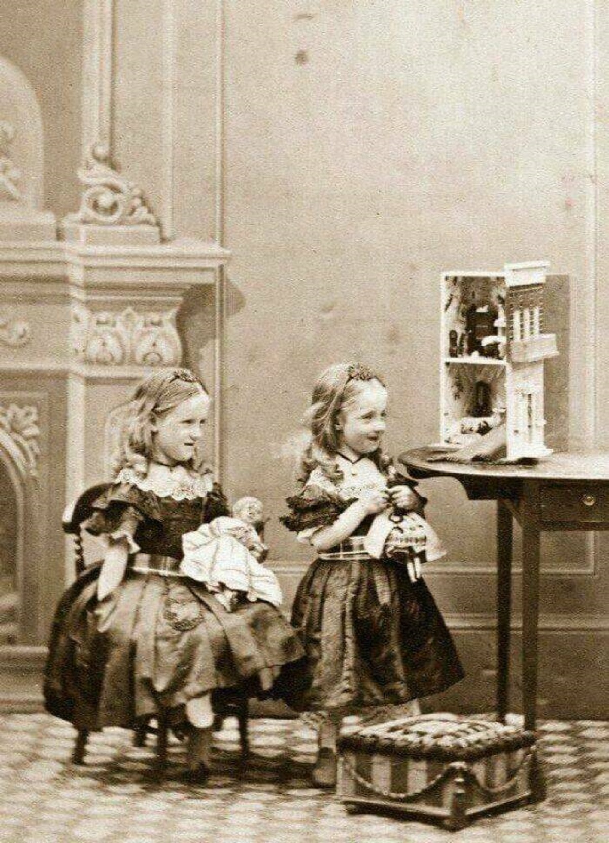 "Two Young Girls Playing With A Doll House, 1850s-1860s"