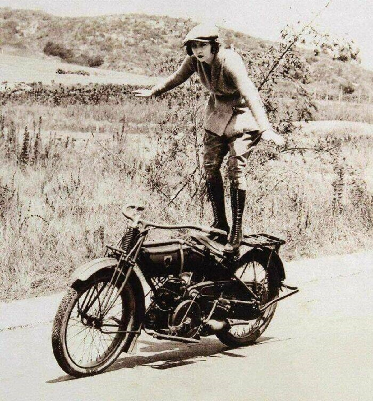 "A Woman Stands While Riding Her Motorcycle, 1920s"