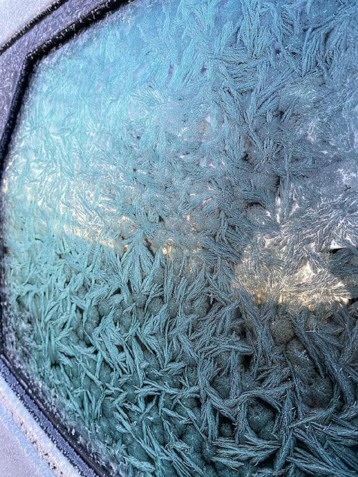 "The Norwegian winter’s decoration on my car window this morning"