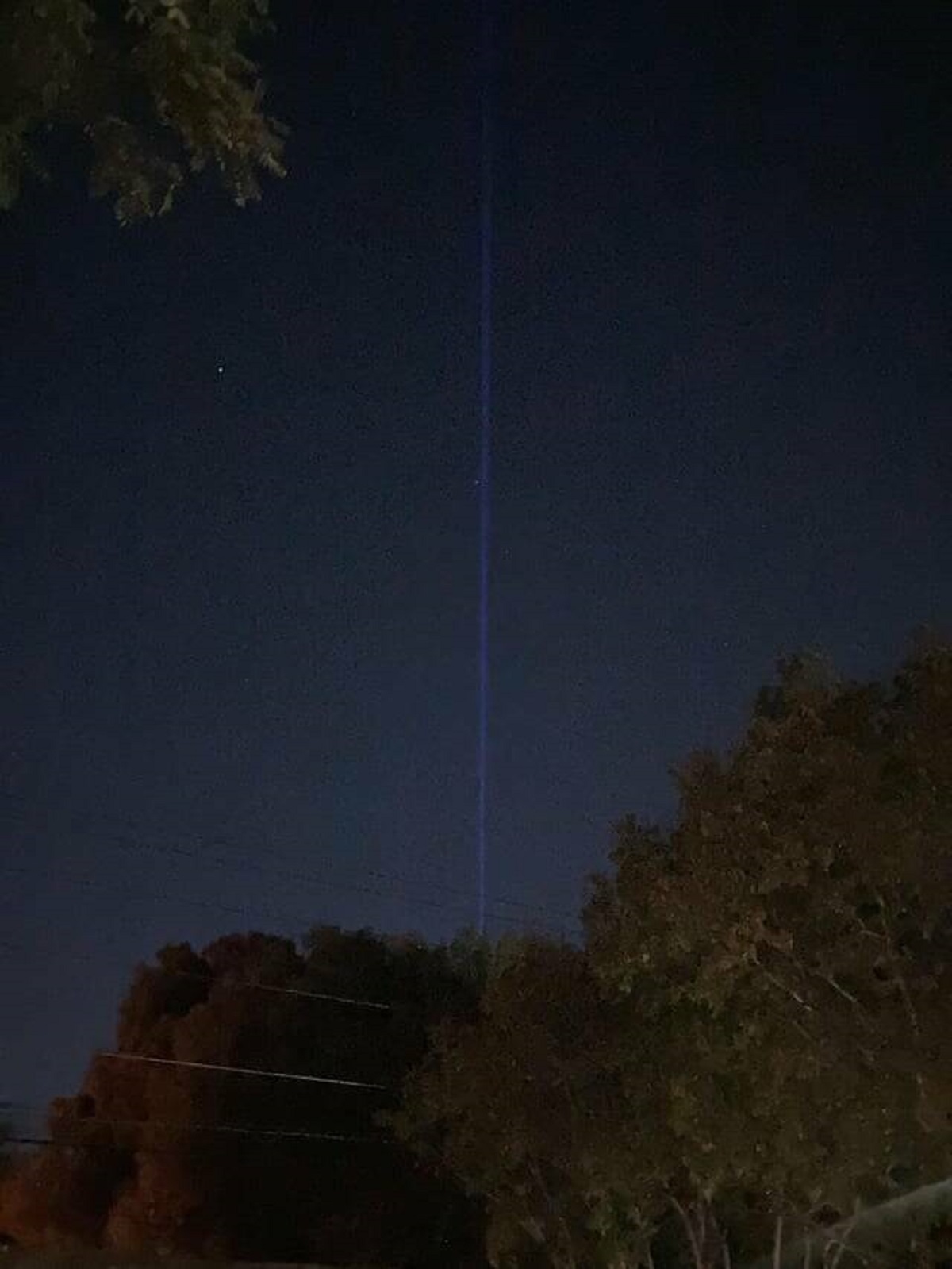 "This weirdly straight blue line in the sky, doesn’t seem to jet/spotlight/etc"