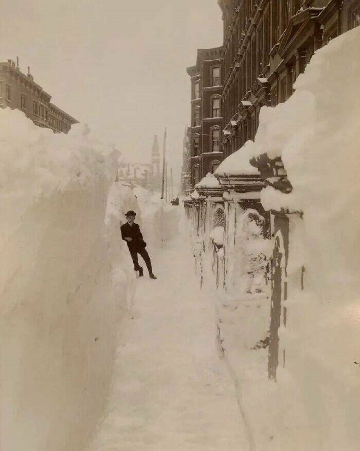 "The Great Blizzard Of 1888 Stands As One Of The Most Severe Blizzards Ever Recorded In American History"

"This tempest rendered the East Coast immobile, depositing snow ranging from 10 to 58 inches (25 to 147 cm) across various regions of New Jersey, New York, Massachusetts, Rhode Island, and Connecticut. The included photograph captures an unidentified young man positioned within a cleared space on Madison Avenue and 40th Street in New York City.

The storm's impact was far-reaching: railways ceased operations, and individuals were confined to their residences for up to a week. Telegraph and railway lines suffered disruptions, prompting the decision to relocate these essential infrastructures underground."