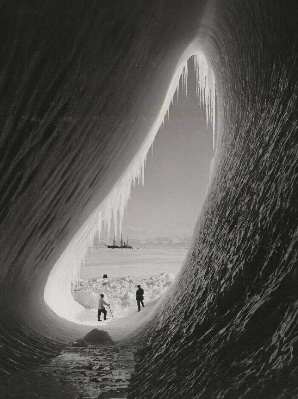 "Grotto In An Iceberg, 1911"

"Geologist Thomas Griffith Taylor and Meteorologist Charles Wright photographed on the 5 January 1911 at the entrance of a grotto in the side of an iceberg with the Terra Nova ship in the background. This was a part of the British Antarctic Expedition led by Captain Robert Falcon Scott which lasted from 1910-1913."