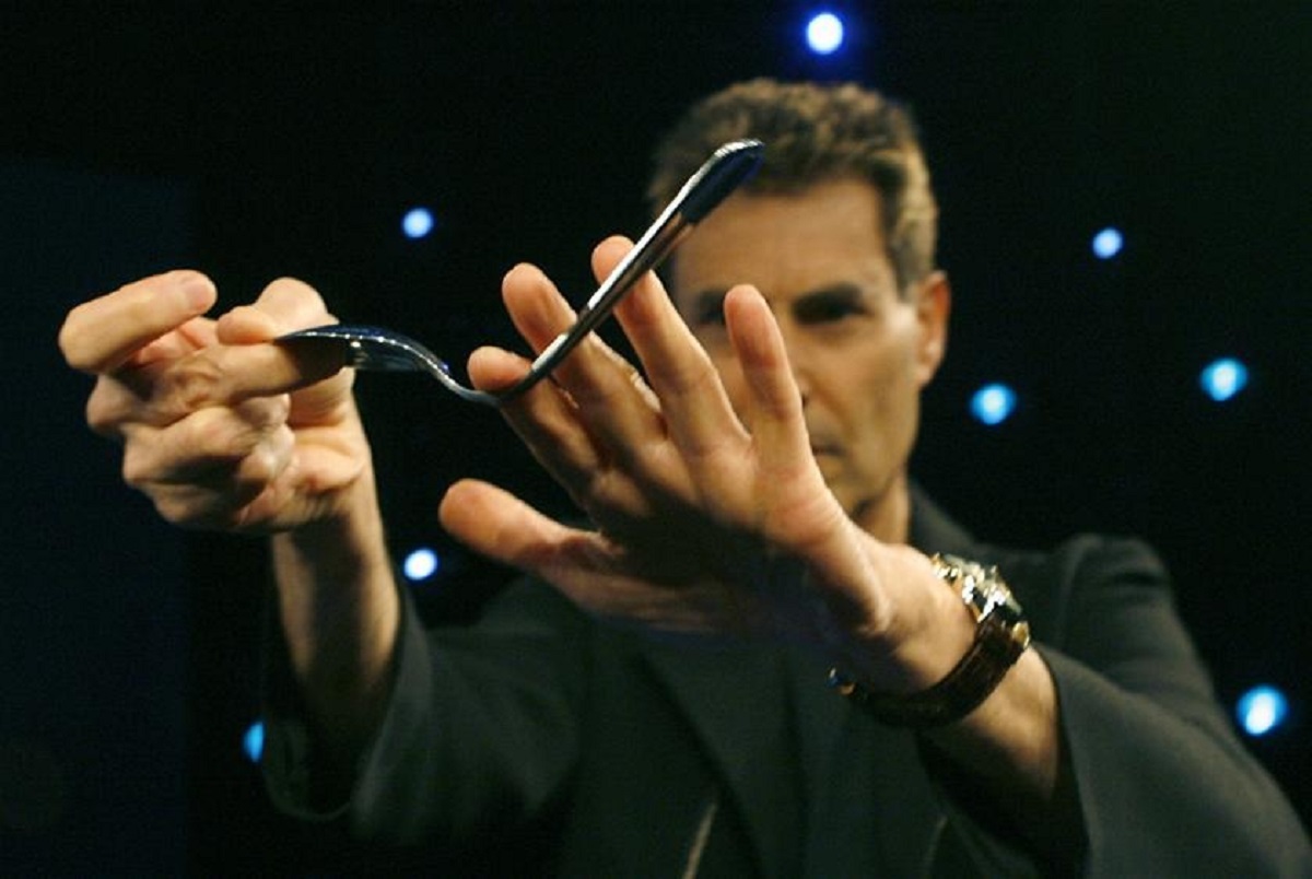 The bending spoon illusion is a common feature at events with food service. The magician selects a random spoon from a table, vigorously shakes it until it appears bent, and swiftly restores it to its original state. Mastery of sleight of hand is essential for this trick, which involves a concealed small silver coin in the magician's hand. The coin serves as the apparent tip of the spoon, creating the illusion of deformation while it remains motionless.