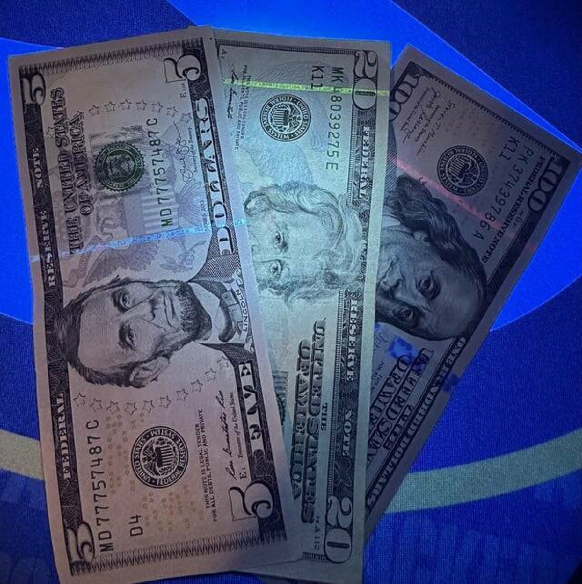 "Different values of US currency have a strip in them that glow different colors under UV light."