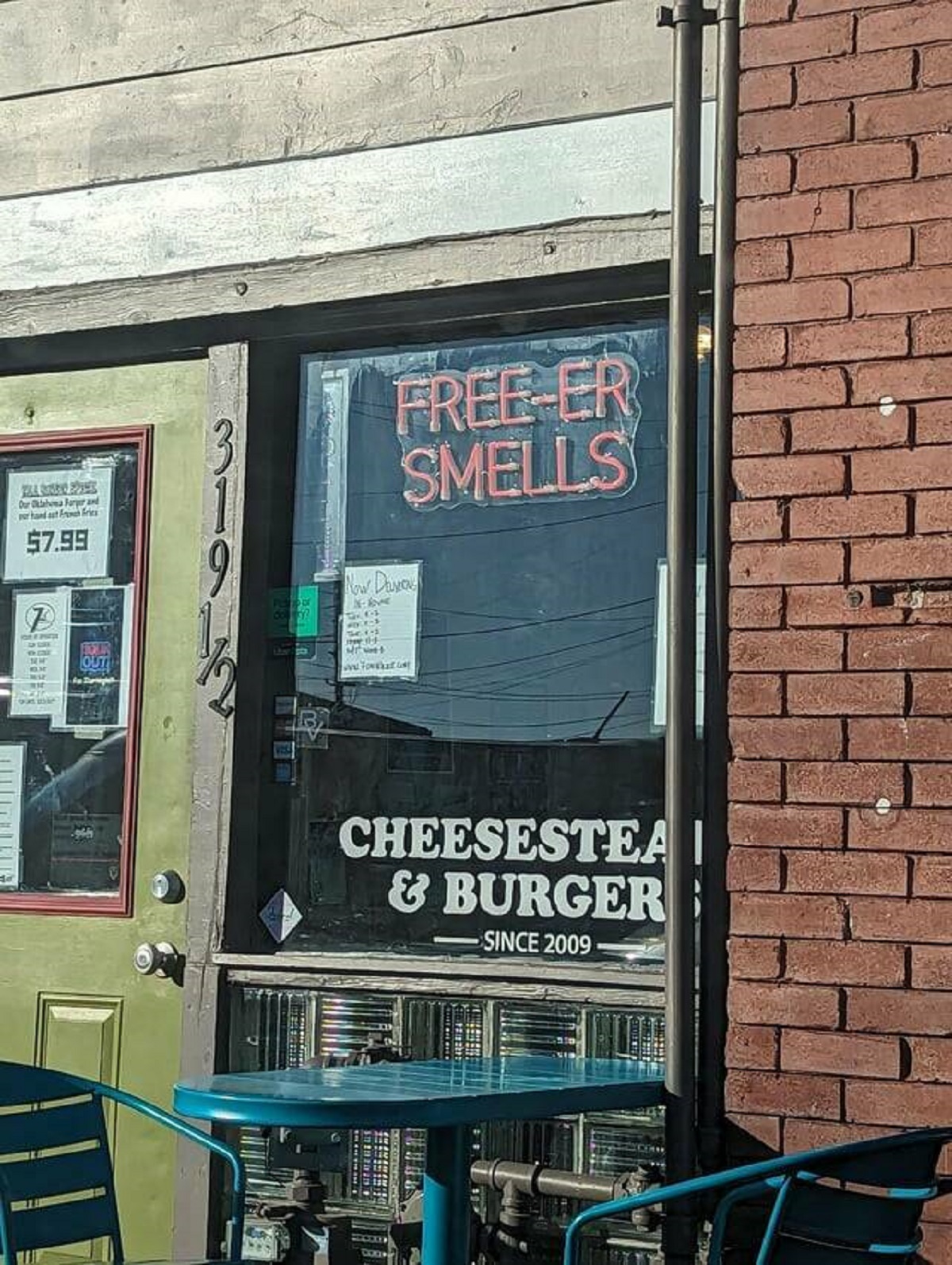 "This local restaurant across from a Jimmy John's has a "free-er smells" sign"