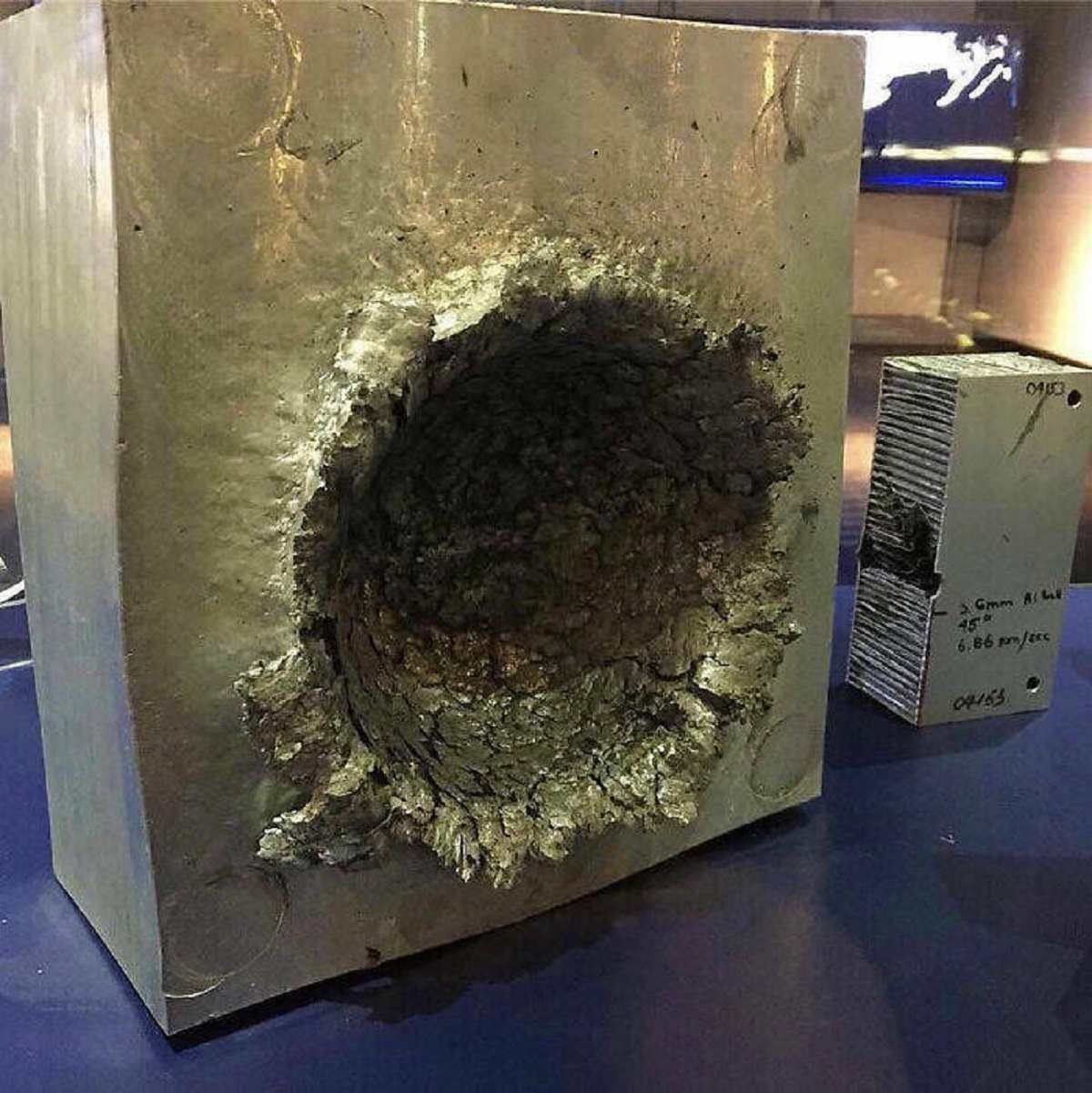 "This Is What Happens To Aluminum When A 1/2 Oz Piece Of Plastic Hits It At 15,000 Mph In Space"