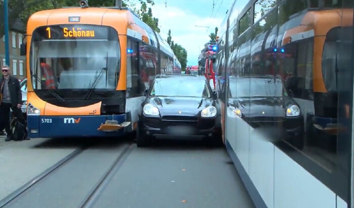 Porsche Driver Attempted To Pass Tram, Gets Stuck Between Two Trains