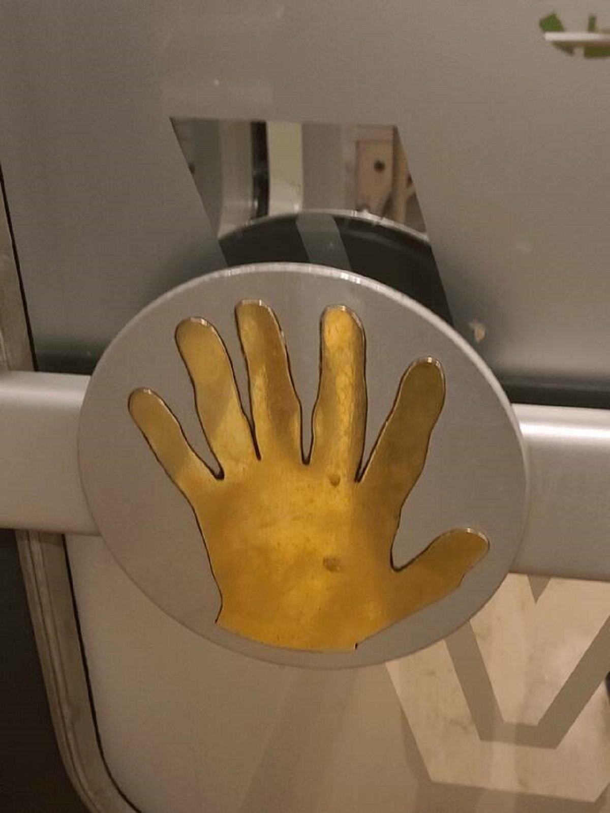 "The hand on this push-door bar on a train in Finland has six fingers"