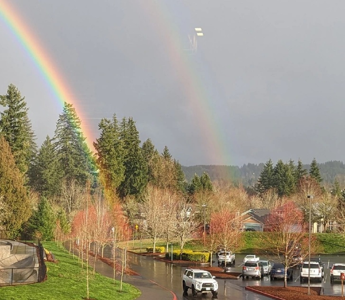 In the parking lot, a pair of rainbows appeared side by side. True beauty!