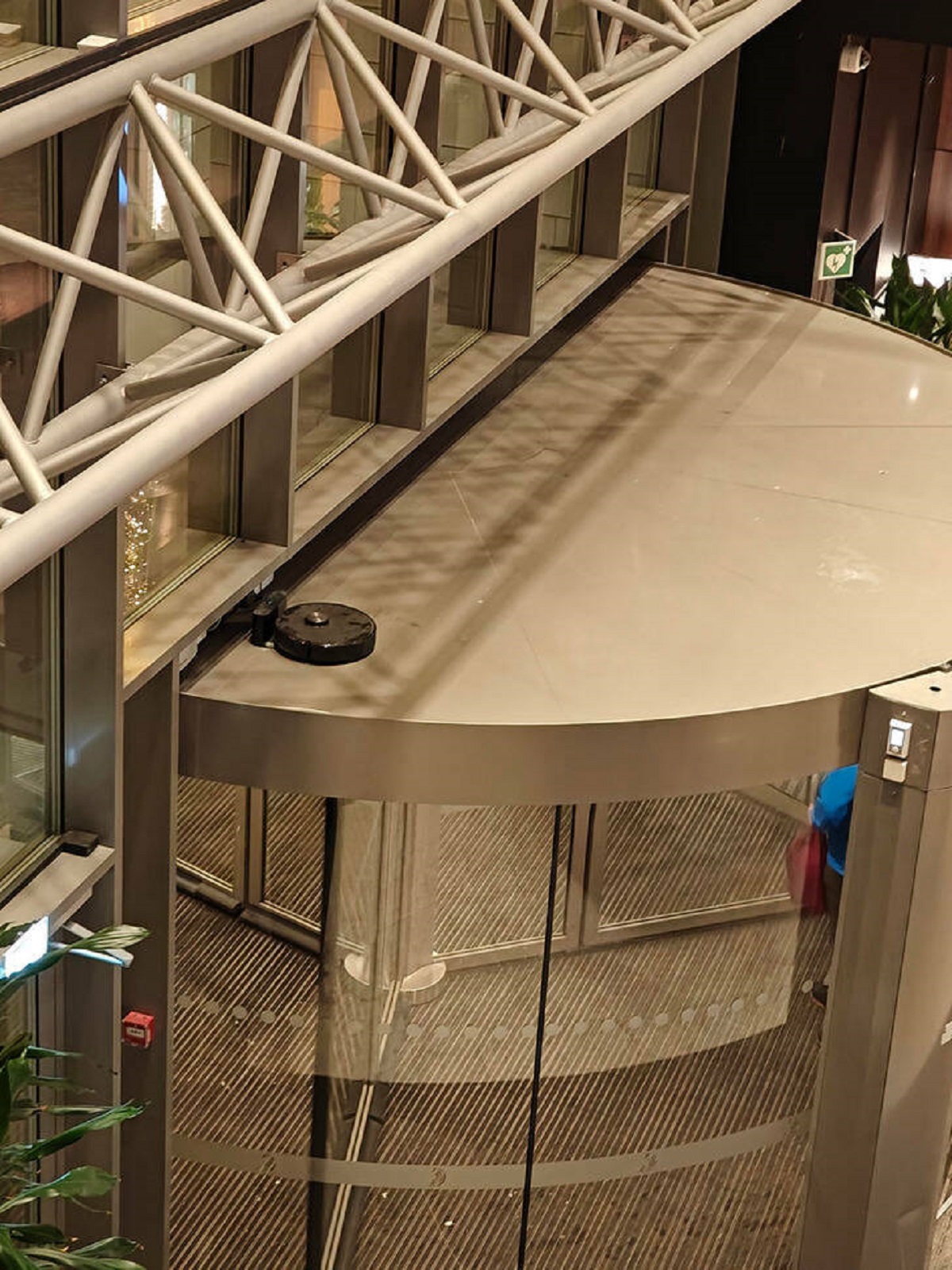 "Just saw this Roomba on top of a Norwegian mall door."