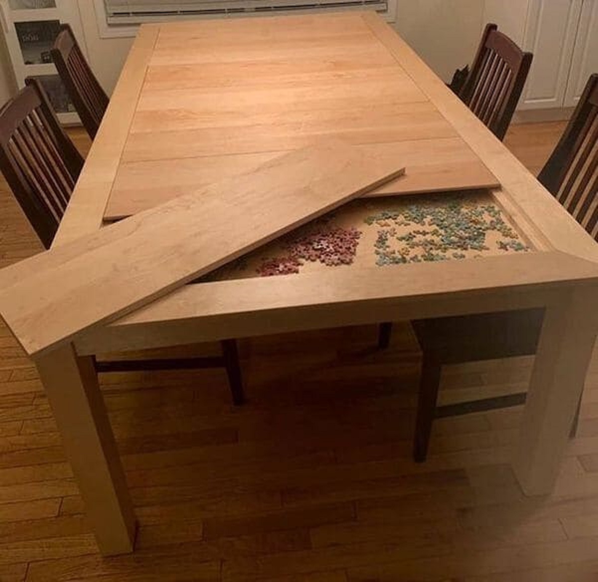 “This dining table has a hidden game compartment under the table.”