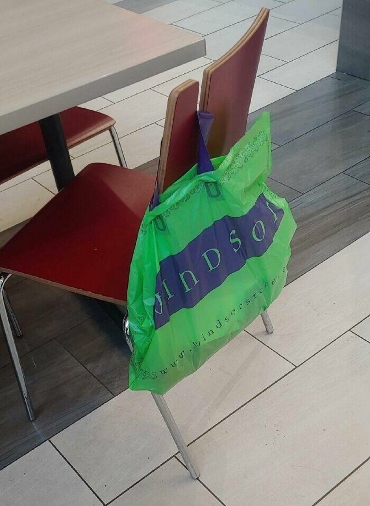 "This Chair In The Food Court Of A Mall Has A Notch Cut Out For Your Bags"