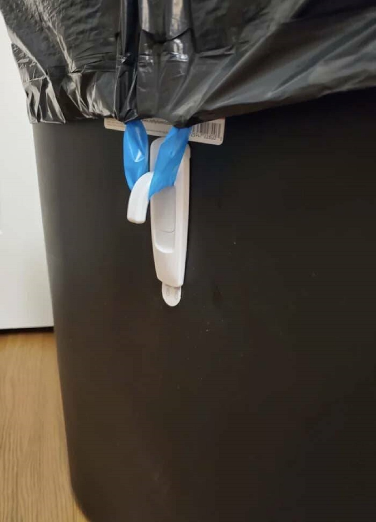 "I use a 3M hanger upside down to keep trash bags in place."