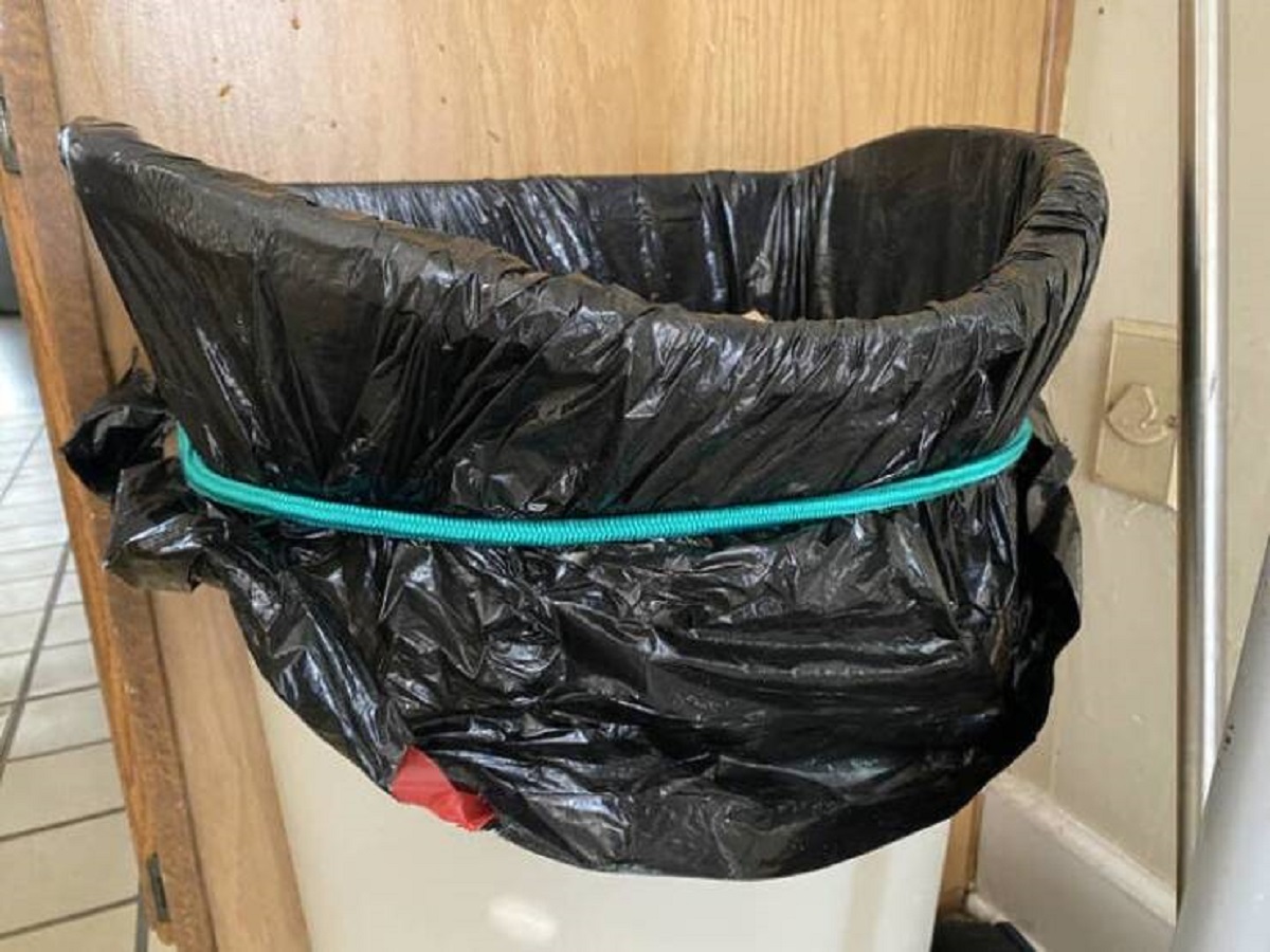 "Use a bungee cord to keep the trash bag from slipping."