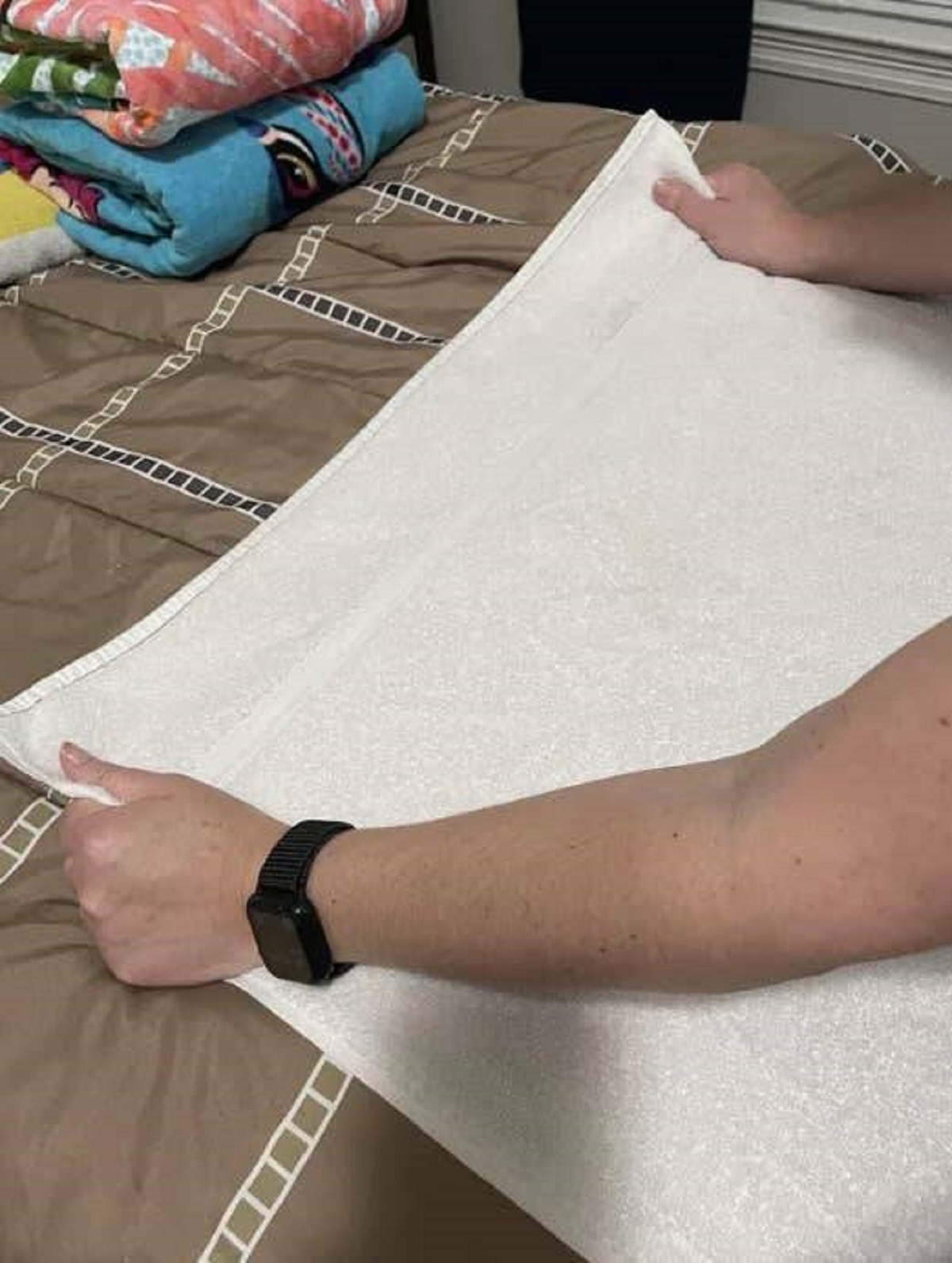 "Stretch your towels. Every time you fold your towels, stretch the short ends. This prevents that weird cinch that prevents them from folding nicely. This towel is likely 15 years old. No bunch!"