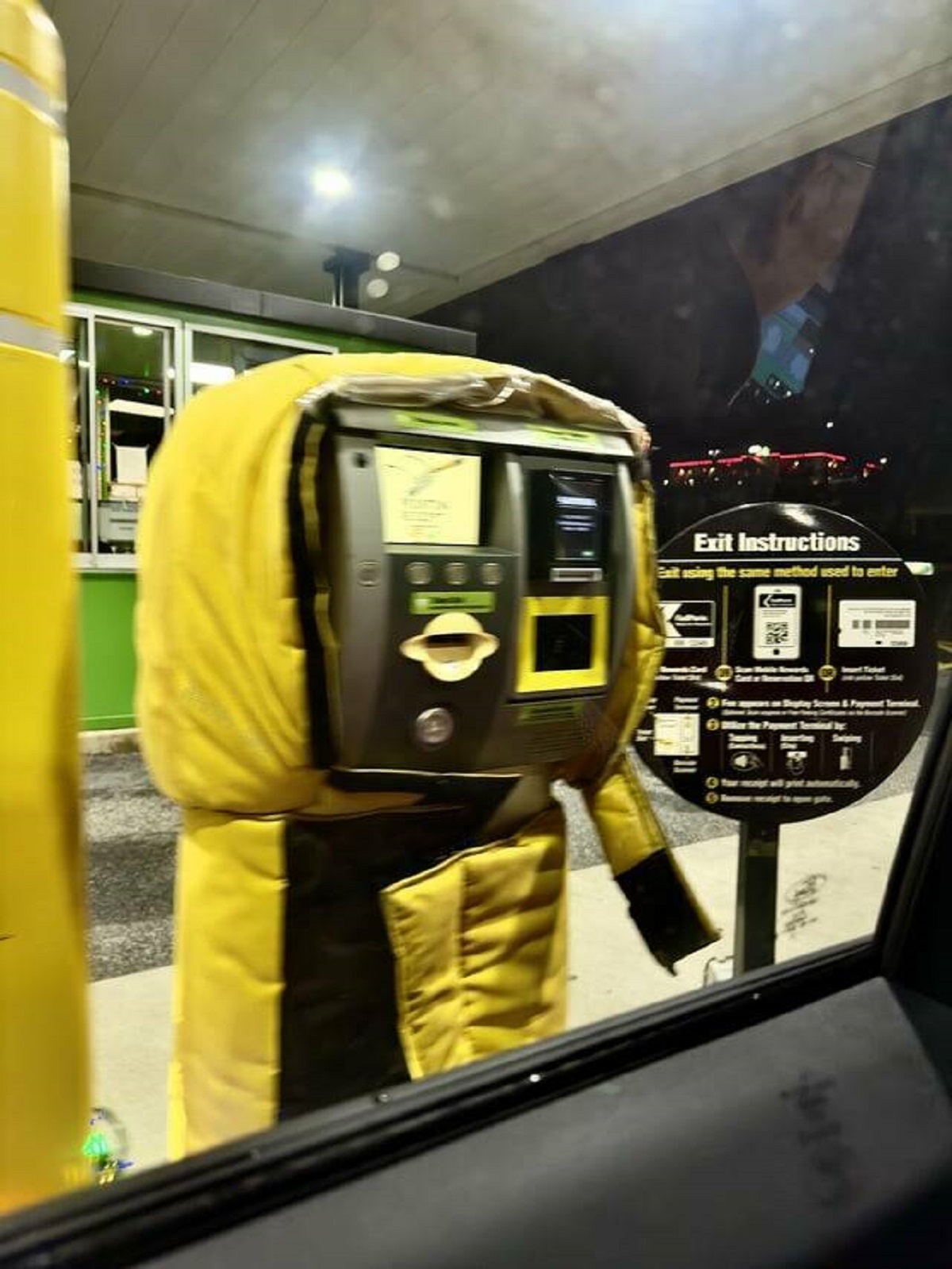 "Parking meter wearing a little winter jacket, perfectly sized"