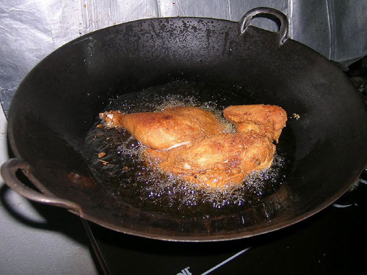 The earliest evidence for fried chicken is from 1500 BCE. It comes from Luzon in the Philippines. The bones that documented some 50k of them from a midden heap show two things. First, they are from Green Jungle Fowl, the wild ancestor of modern chickens, that were kept penned their entire lives based on wing development . This happens when you clip the wing feathers to keep them from flying. Secondly we know the earliest layers was cooked in coconut oil due to the residue worked into the heated bone tips. This also leads local archaeologists to believe the locals were fermenting coconut milk to make a local drink called tuba. This is still one of the methods used today. All in all 3500 years ago my fellow Filipinos were getting drunk and eating fried chicken. Not much has changed.