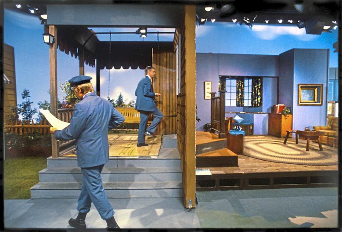 David Newell looks over his lines as Fred Rogers enters the house set of “Mister Rogers’ Neighborhood.”