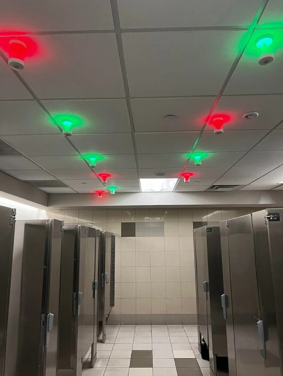 This bathroom displays which stalls are available.