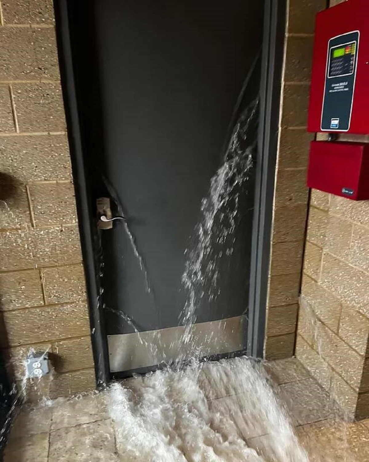"There is a 7ft wall of water from a burst 5” pipe, behind this inward swinging door."