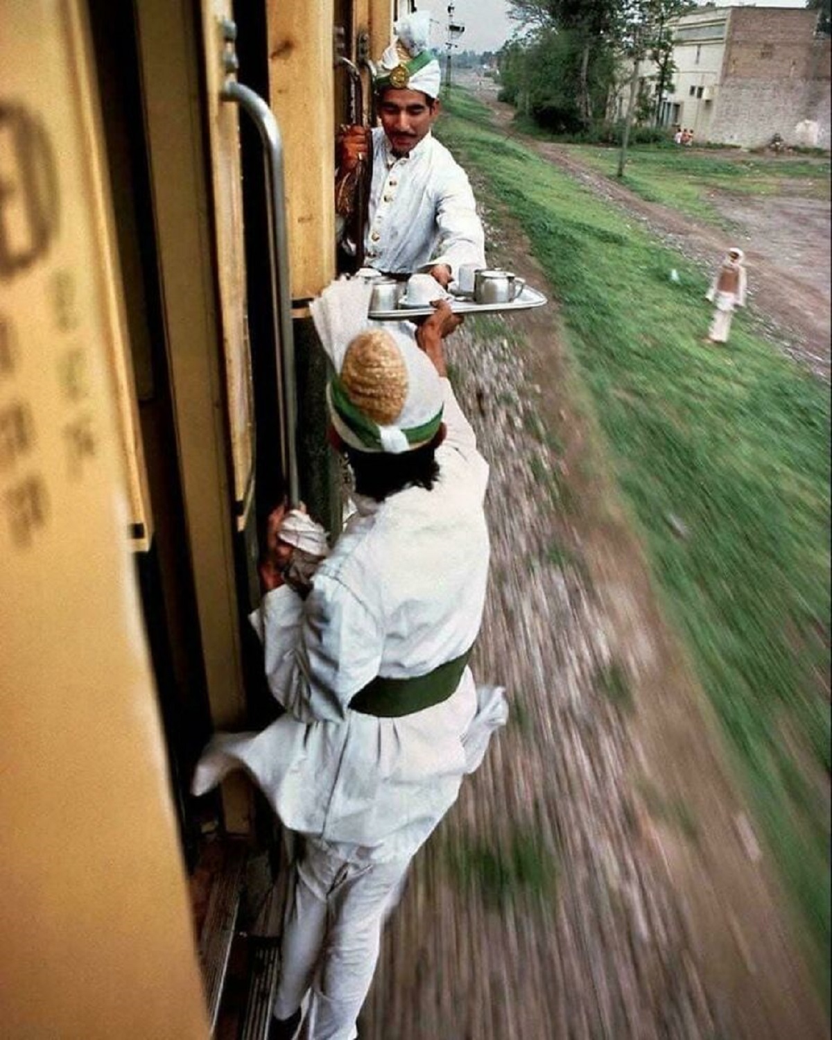 Breakfast Tea Being Passed Between Cars On A Train From Peshawar To Lahore In 1983.